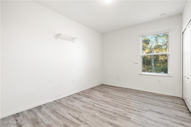 spare room featuring light hardwood / wood-style flooring