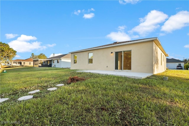 rear view of house featuring a lawn and a patio area