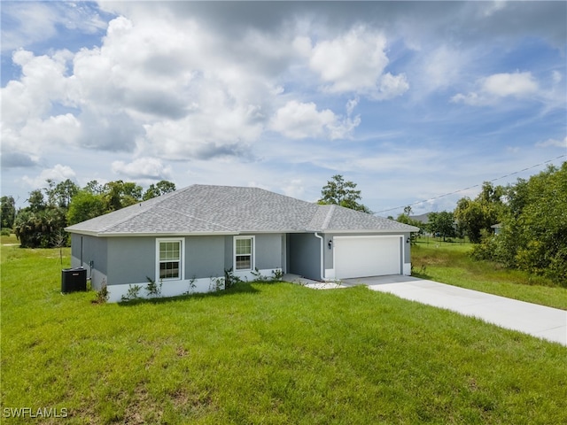 single story home with a garage and a front lawn