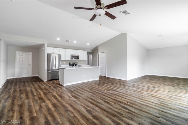 unfurnished living room with dark hardwood / wood-style floors, ceiling fan, and vaulted ceiling