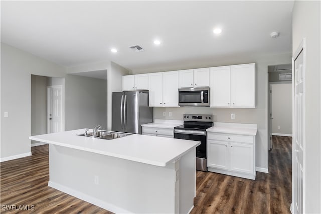 kitchen featuring dark hardwood / wood-style flooring, stainless steel appliances, sink, a center island with sink, and white cabinets