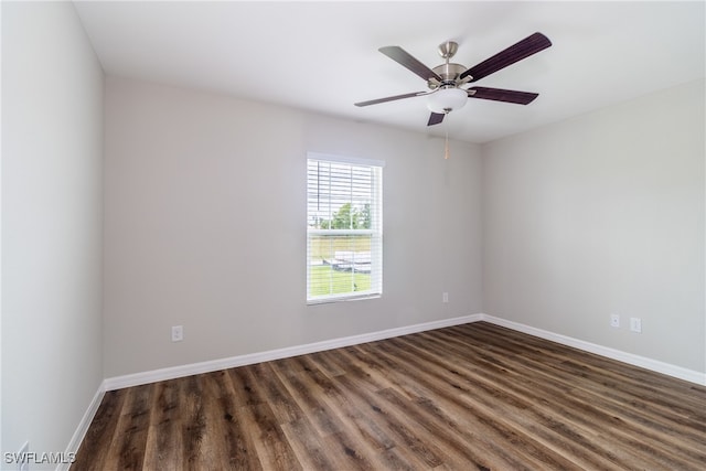 unfurnished room featuring ceiling fan and dark wood-type flooring