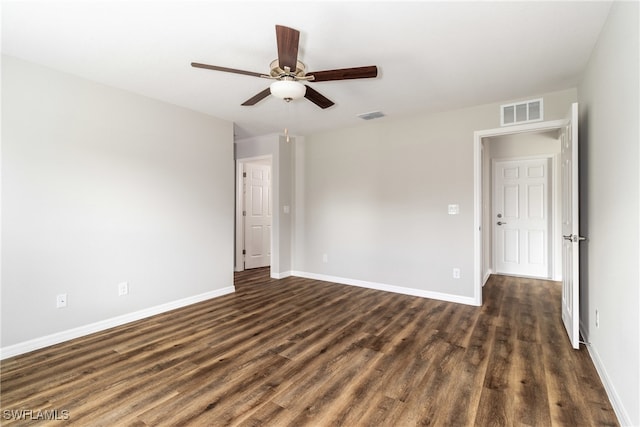 empty room featuring ceiling fan and dark wood-type flooring