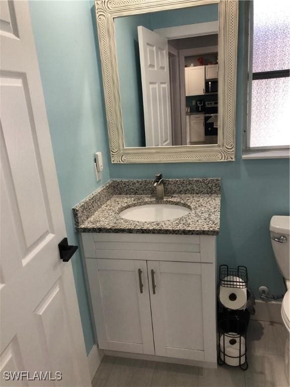 bathroom with vanity and toilet