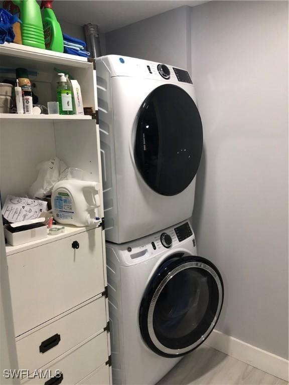 clothes washing area with stacked washer and dryer