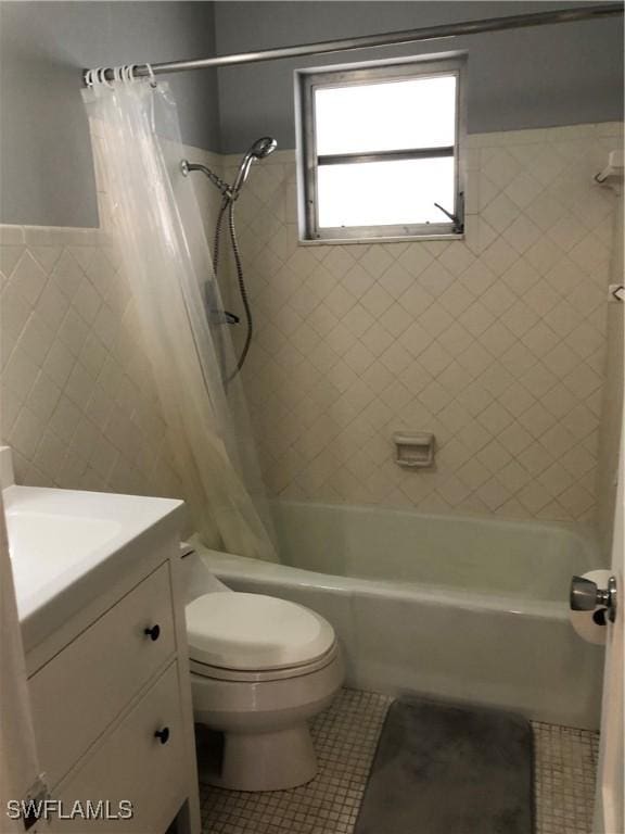 full bathroom with shower / tub combo, tile patterned floors, vanity, tile walls, and toilet