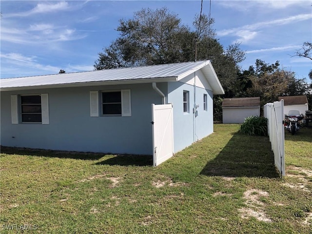 view of side of home with a yard