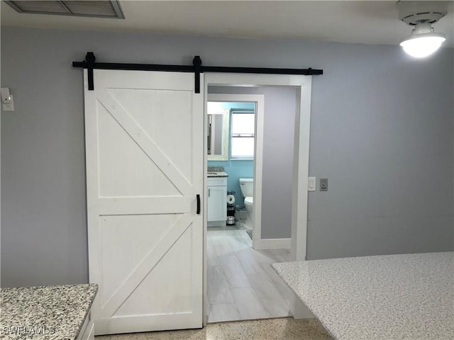 hallway featuring a barn door