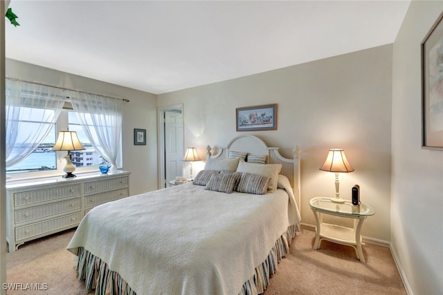 bedroom featuring light carpet