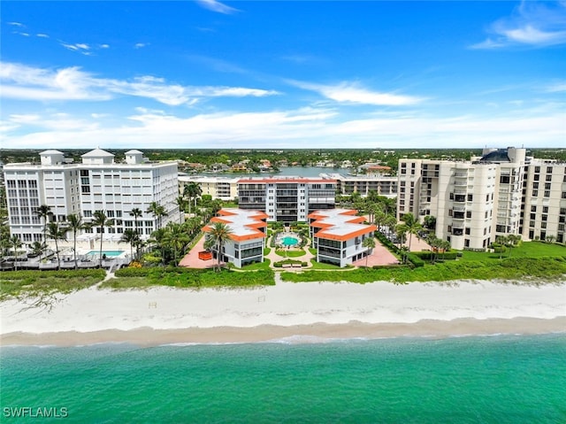 birds eye view of property with a beach view and a water view