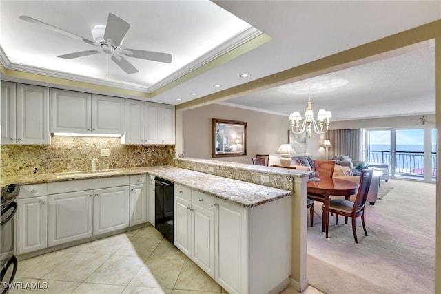 kitchen featuring light carpet, ceiling fan with notable chandelier, sink, black dishwasher, and kitchen peninsula