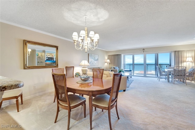 dining area with a textured ceiling, light colored carpet, crown molding, and a chandelier