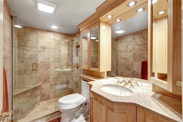 bathroom featuring vanity, toilet, and walk in shower