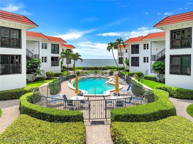 view of pool with a water view