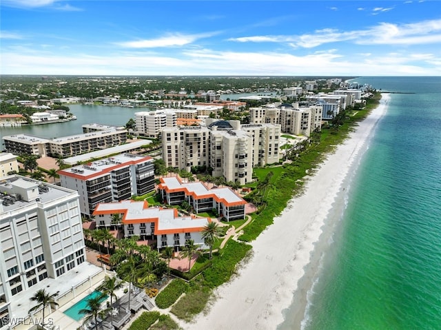 birds eye view of property with a water view and a view of the beach