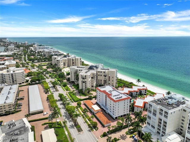 drone / aerial view with a beach view and a water view