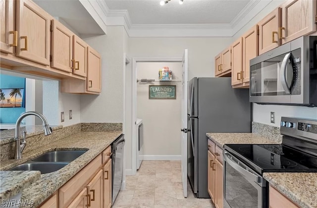 kitchen with a textured ceiling, light brown cabinets, sink, and stainless steel appliances