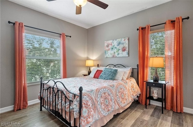 bedroom with ceiling fan and wood-type flooring