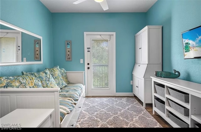 interior space with ceiling fan and wood-type flooring