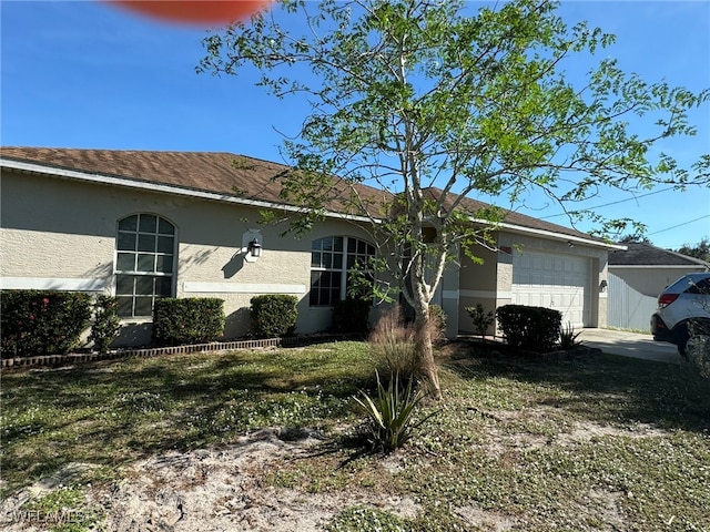 view of front of house with stucco siding and an attached garage