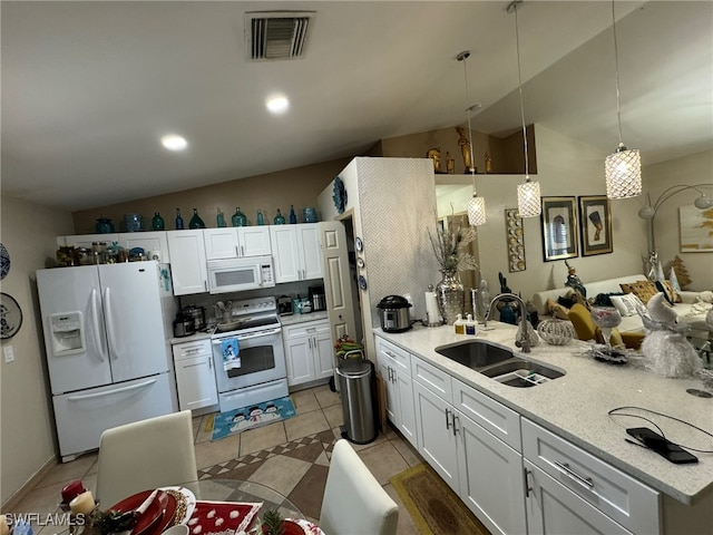 kitchen with sink, hanging light fixtures, lofted ceiling, white appliances, and white cabinets