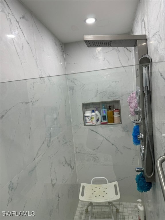 bathroom featuring a shower with shower door