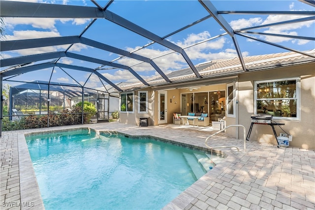 view of pool featuring a patio, ceiling fan, and a lanai