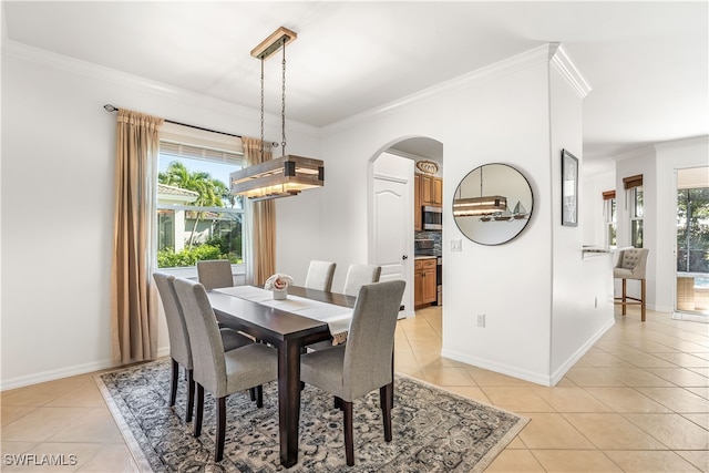 tiled dining area featuring crown molding