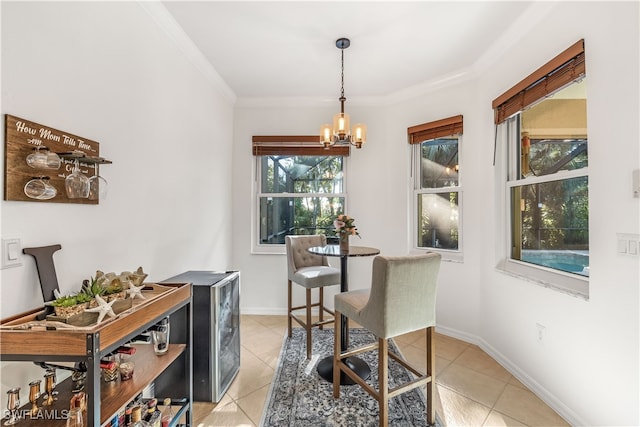 tiled dining space featuring ornamental molding and a notable chandelier