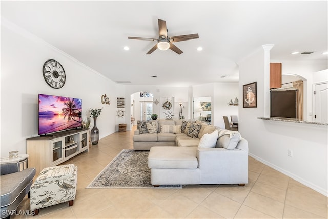 living room featuring ceiling fan, light tile patterned flooring, and crown molding