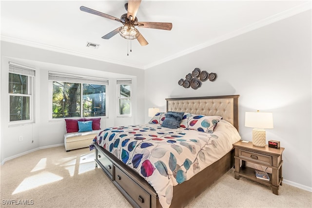 bedroom with ceiling fan, light carpet, and ornamental molding