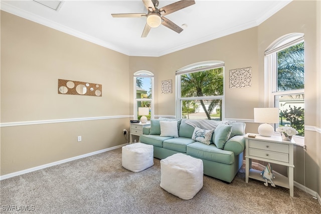 living room with carpet floors, ceiling fan, and ornamental molding