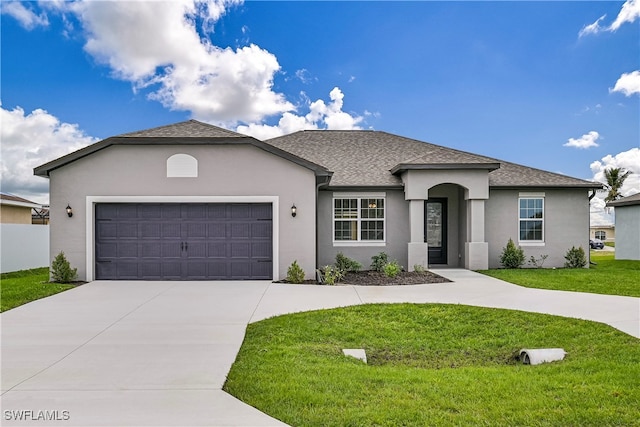 view of front of home with a front yard and a garage