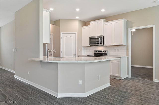 kitchen featuring dark hardwood / wood-style flooring, sink, white cabinetry, and stainless steel appliances