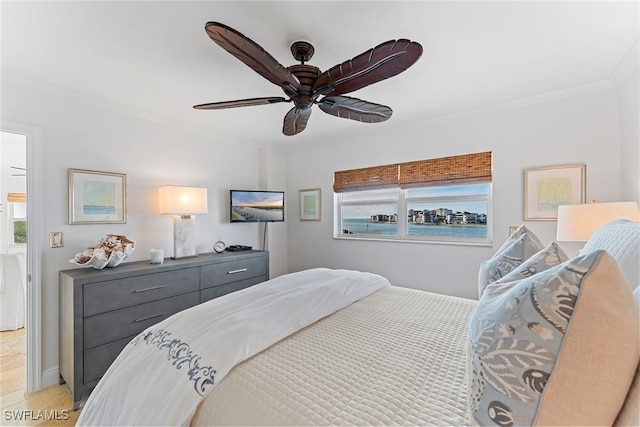 bedroom featuring ceiling fan and crown molding