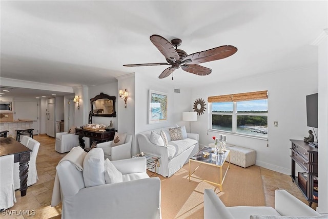 living room featuring ceiling fan and ornamental molding