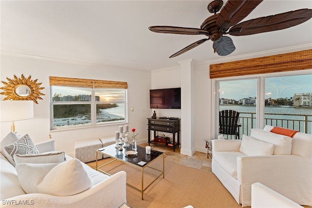 living room featuring ceiling fan and crown molding