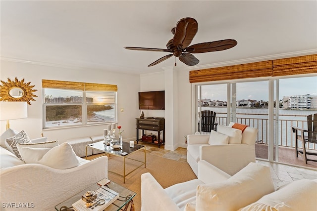 living room with plenty of natural light, ceiling fan, and crown molding