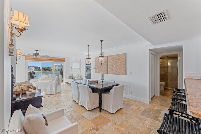 dining room with ceiling fan and crown molding