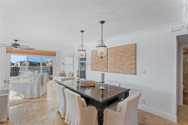 dining space featuring ceiling fan and crown molding