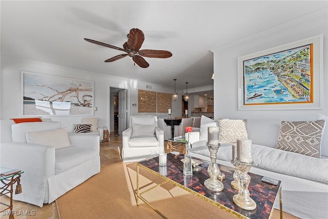 living room with ceiling fan and crown molding