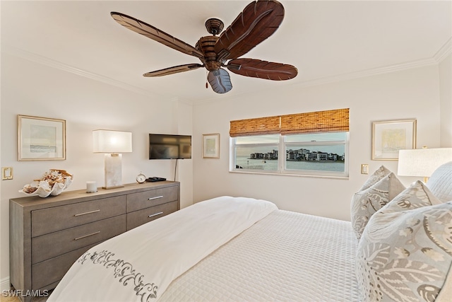 bedroom with ceiling fan and ornamental molding