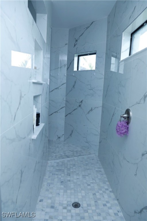 bathroom featuring tiled shower