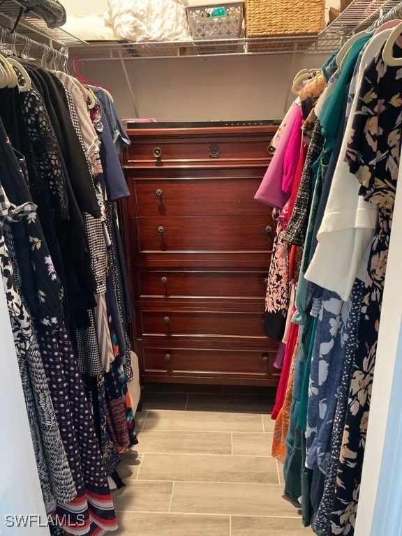 spacious closet featuring light hardwood / wood-style floors