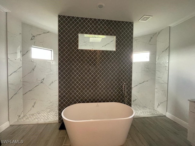 bathroom with hardwood / wood-style flooring and independent shower and bath