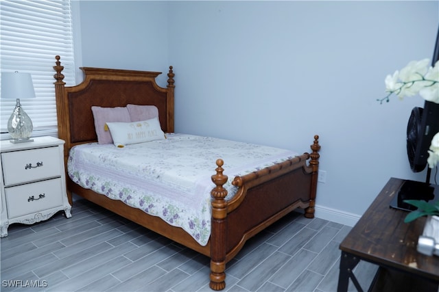 bedroom with dark wood-type flooring