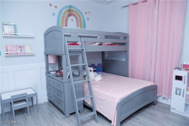 bedroom with light hardwood / wood-style floors and ornamental molding