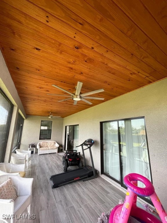 workout area featuring hardwood / wood-style flooring, vaulted ceiling, ceiling fan, and wooden ceiling