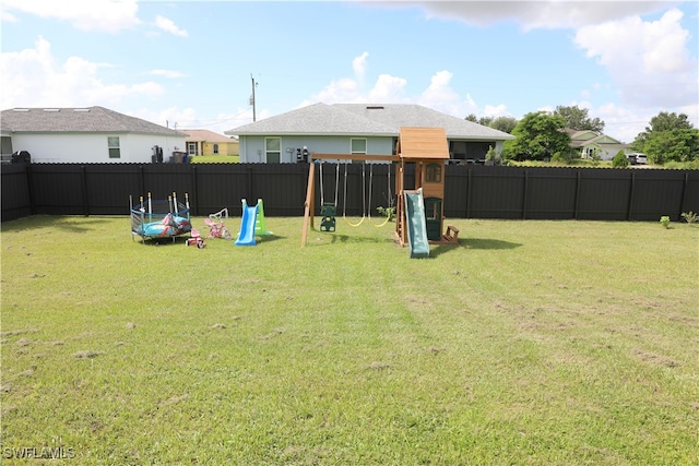 view of yard featuring a trampoline and a playground