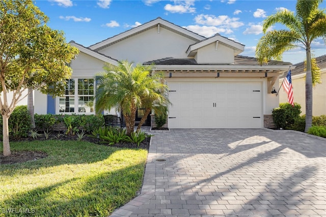 view of front of property with a garage and a front yard